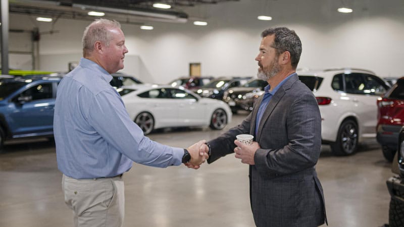 member shaking hands with a denver auto broker